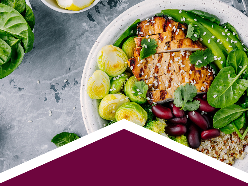 Grilled chicken with salad, black olives, cous cous, and grilled brussels sprouts